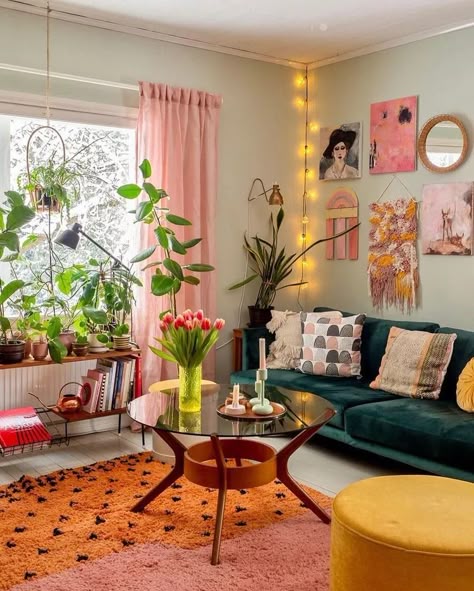 a living room filled with furniture and lots of plants