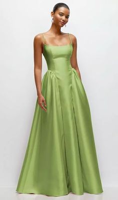 a woman in a green dress posing for the camera