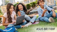 three children sitting on the grass with their laptops and cell phones in front of them