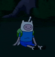finn from adventure time is sitting on the ground