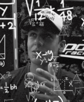 a man wearing a red bull hat is surrounded by equations and numbers