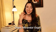 a woman says oops miranda oops in front of a lamp